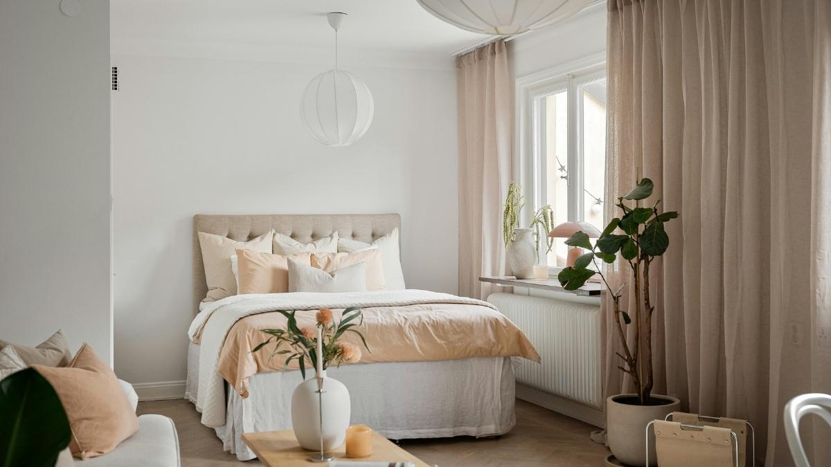 Soft beige drapes warming up a white-walled Scandinavian living room