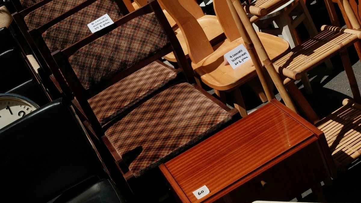Garage sale furniture display with handwritten price tags