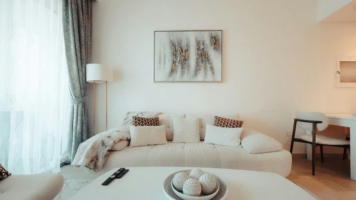 Designer-styled white living room with layered textures and a fresh sofa