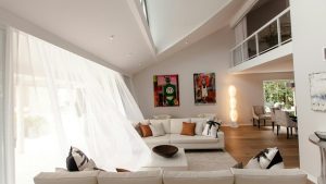White curtain and sofa maintenance shown in a spotless, sunlit living room