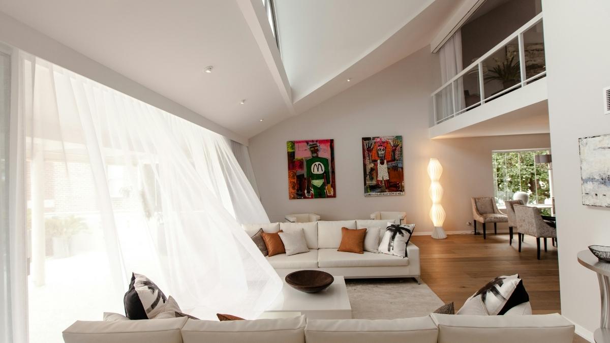 White curtain and sofa maintenance shown in a spotless, sunlit living room