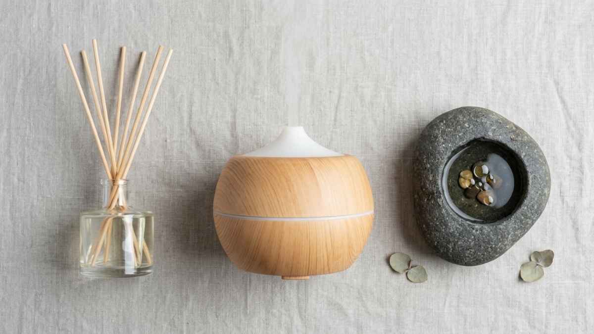 Collection of different home scent diffusers on a neutral flat lay background